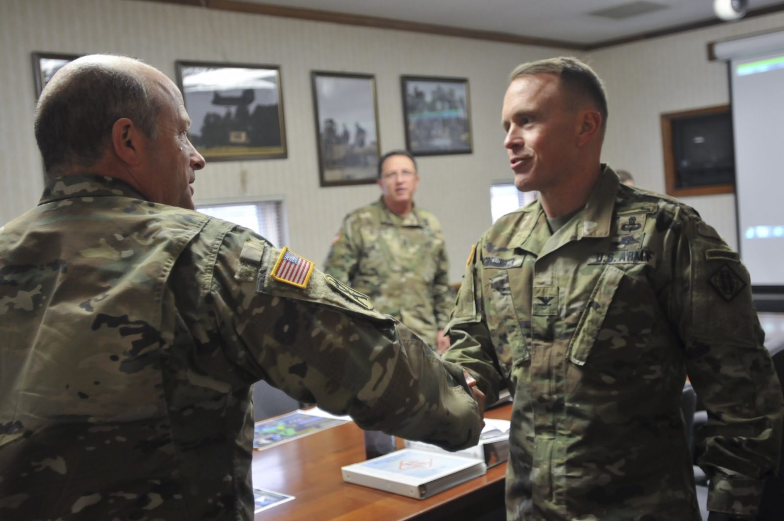 soliders shaking hands in office